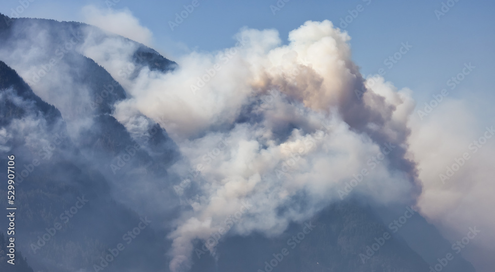 BC Forest Fire and Smoke over the mountain near Hope during a hot sunny summer day. British Columbia, Canada. Wildfire natural disaster BC Forest Fire and Smoke over the mountain near Hope during a hot sunny summer day. British Columbia, Canada. Wildfire natural disaster