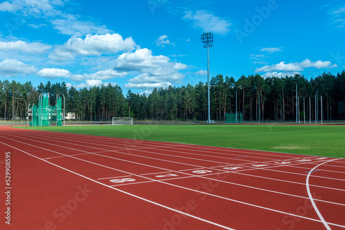 Red running track in stadium. Sport theme background. Horizontal sport theme poster, greeting cards, headers, website and app