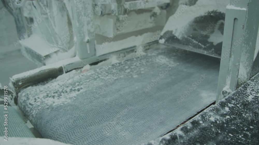 Bags with marble aggregate on conveyor at natural stone processing factory
