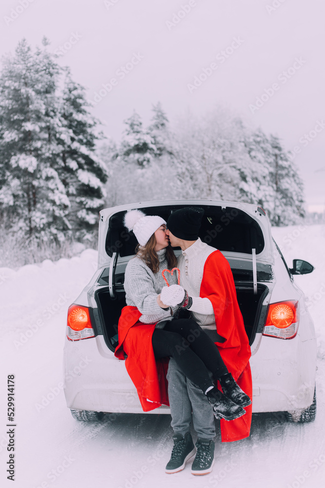 A couple in love in the trunk of a car lifestyle , An article about couples in love. An article about winter . Valentine's day.