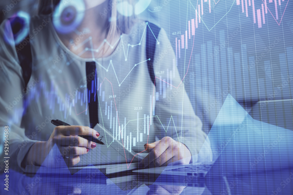 Double exposure of businesswoman hands typing on computer and financial graph hologram drawing. Stock market analysis concept. Double exposure of businesswoman hands typing on computer and financial graph hologram drawing. Stock market analysis concept.