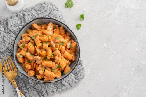 Fusilli pasta with chicken. Cooked in spicy sauce from tomatoes, onion, garlic with chicken meat