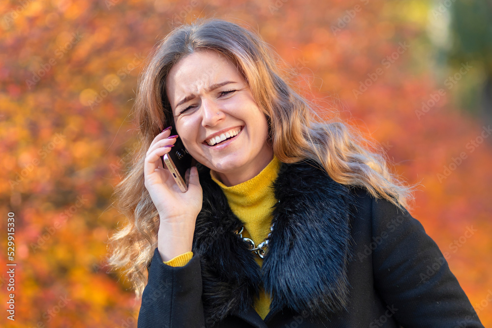 cheerful white toothy smile girl, young happy woman whitened teeth laughing speaking phone. portrait smiling lady on background of orange leaves in autumn park. Fashion girls fall with smartphone cheerful white toothy smile girl, young happy woman whitened teeth laughing speaking phone. portrait smiling lady on background of orange leaves in autumn park. Fashion girls fall with smartphone