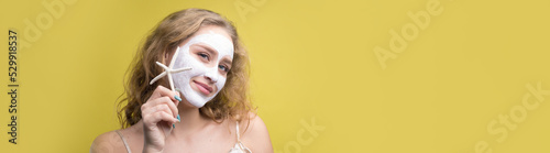 The girl makes procedures with a cosmetic mask on her face.