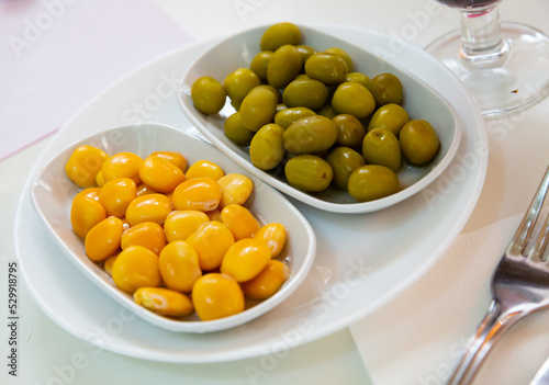 Marinated whole green olives and pickled yellow lupini beans. Vegetarian snack