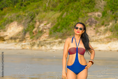 Woman body pretty stand smile with swimsuit at beach