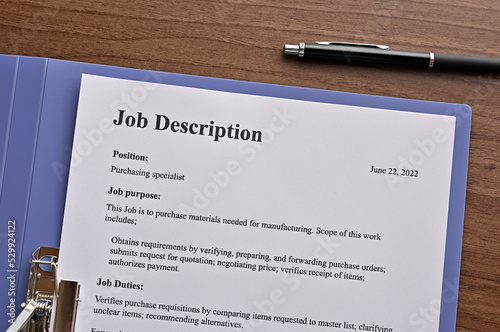 There is dummy documents that created for the photo shoot on the desk about Job Description.