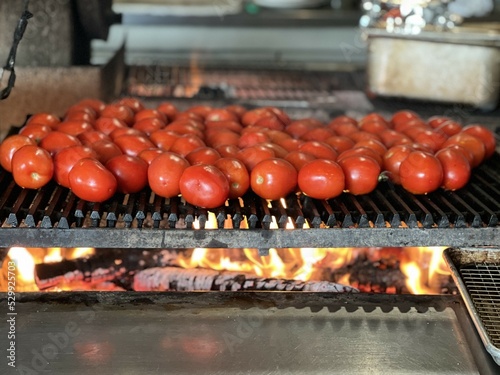 tomatoes being roasted over a wood burning stove