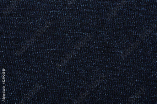 Texture of dark blue jeans as background, closeup