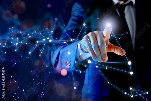 Man using virtual screen with connection lines presenting innovation network linkage on dark background
