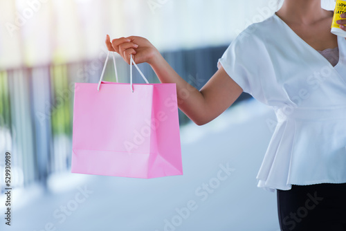 woman holding shopping bags. person holding shopping bags