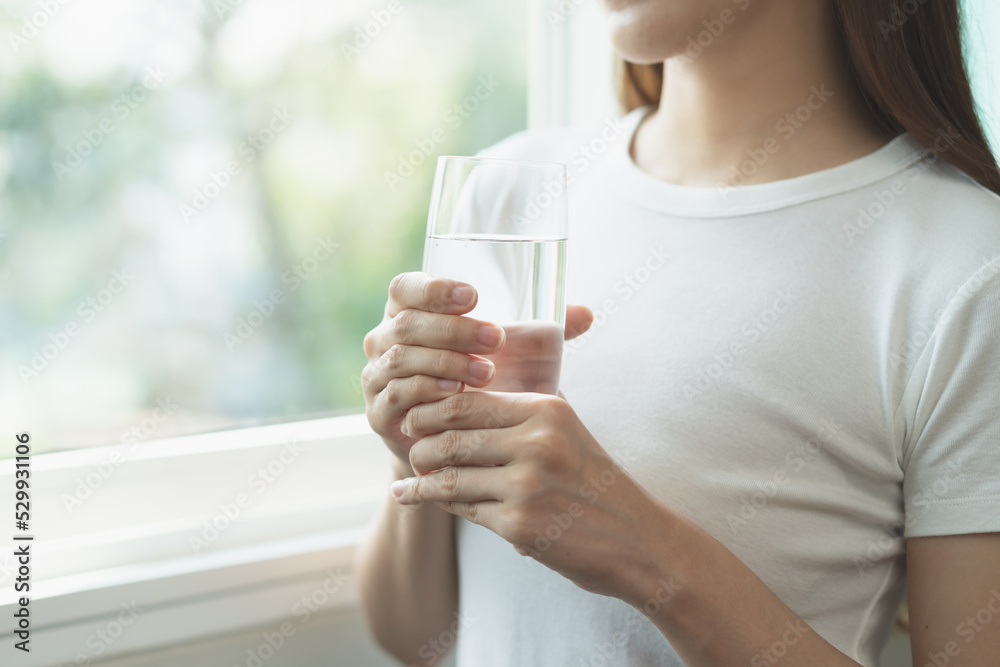 Clean freshwater concept. Woman drink mineral water in the morning for good health. Clean freshwater concept. Woman drink mineral water in the morning for good health.