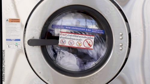 Washing machines with dirty laundry, public coin laundry, Self-service laundromat, laundrette.
