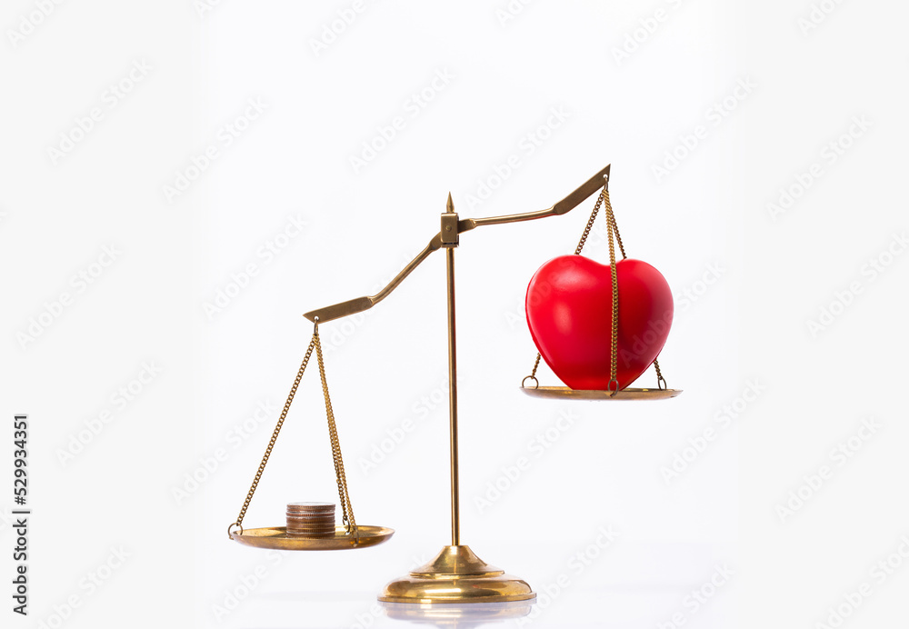Love Money Symbol Concept. Red Heart shape on balance scale exchange trade for Materialism, stack coin, bitcoin and buy sale lover. Love for money on balance scale isolated on white background
