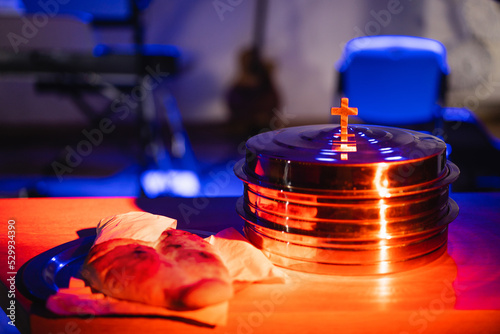 The process of breaking bread in the modern church. Breaking bread ceremony in protestant church. Religious tradition of breaking bread. Bread and wine.