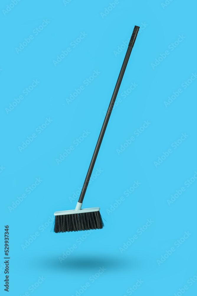Cleaning brush with a handle on a blue background. Cleaning brush with a handle on a blue background.