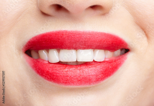 Closeup macro portrait of woman smiling red lips with day beauty makeup