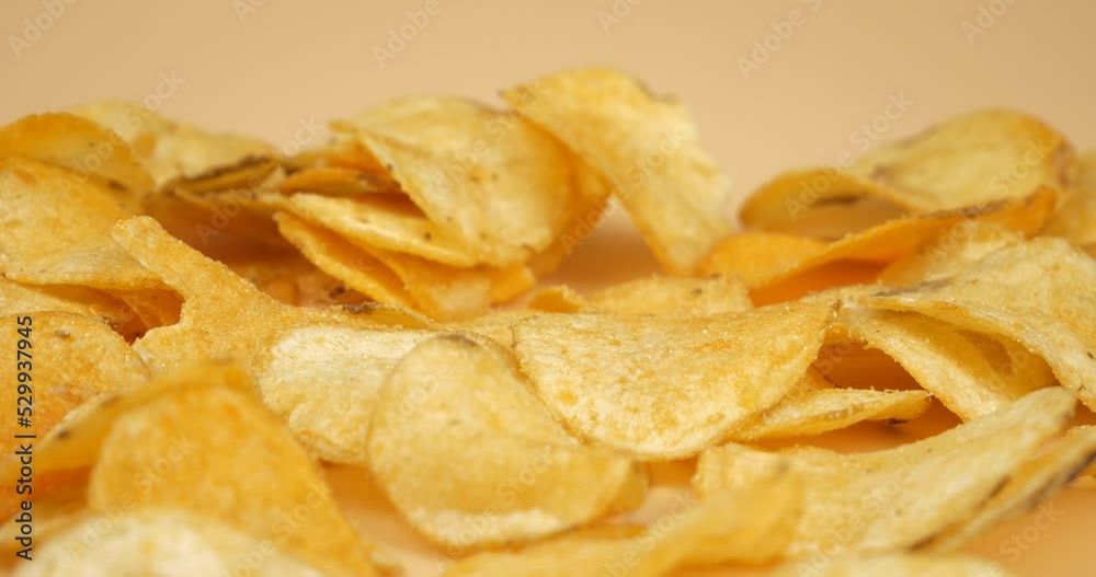 fingers take golden potato chips closeup, fried salty snack. High quality 4k footage fingers take golden potato chips closeup, fried salty snack. High quality 4k footage