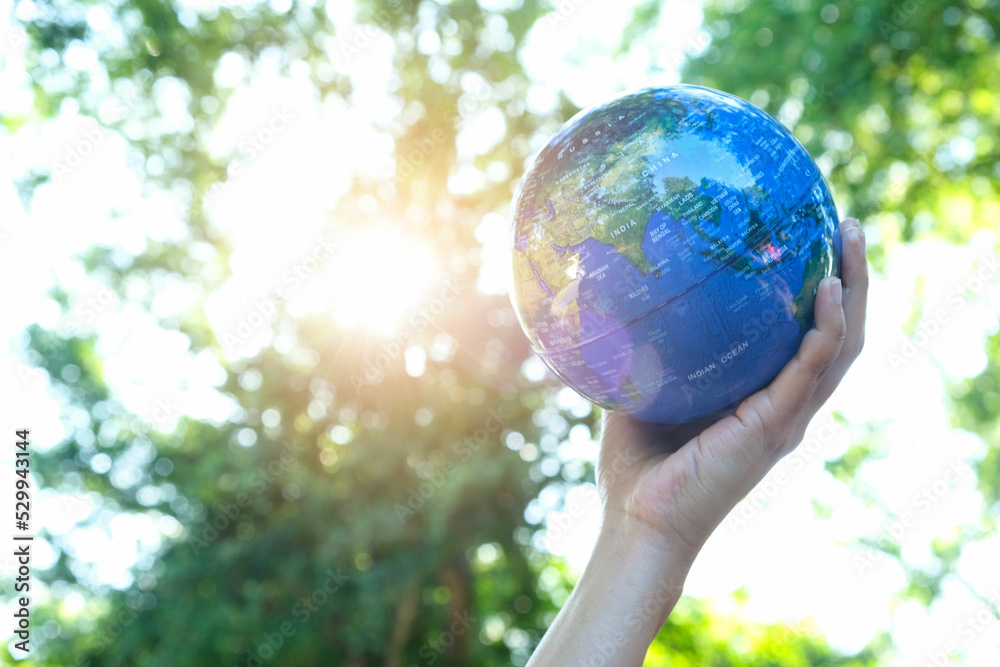 man's hand holding a globe, showing the world's healing, protecting the planet from global warming. man's hand holding a globe, showing the world's healing, protecting the planet from global warming.