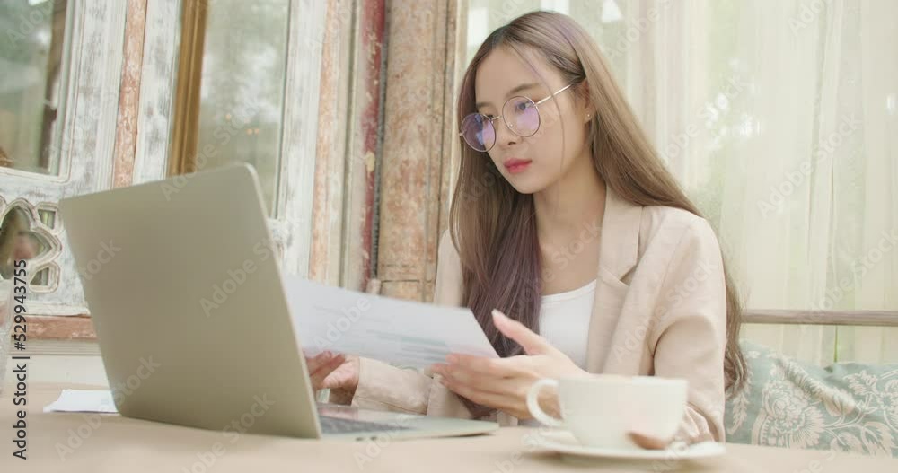 Asian businesswoman freelance using laptop computer remote work in coworking space cafe. Attractive woman talent university girl watching online learning webinar seminar class. working at coffee shop. Asian businesswoman freelance using laptop computer remote work in coworking space cafe. Attractive woman talent university girl watching online learning webinar seminar class. working at coffee shop.