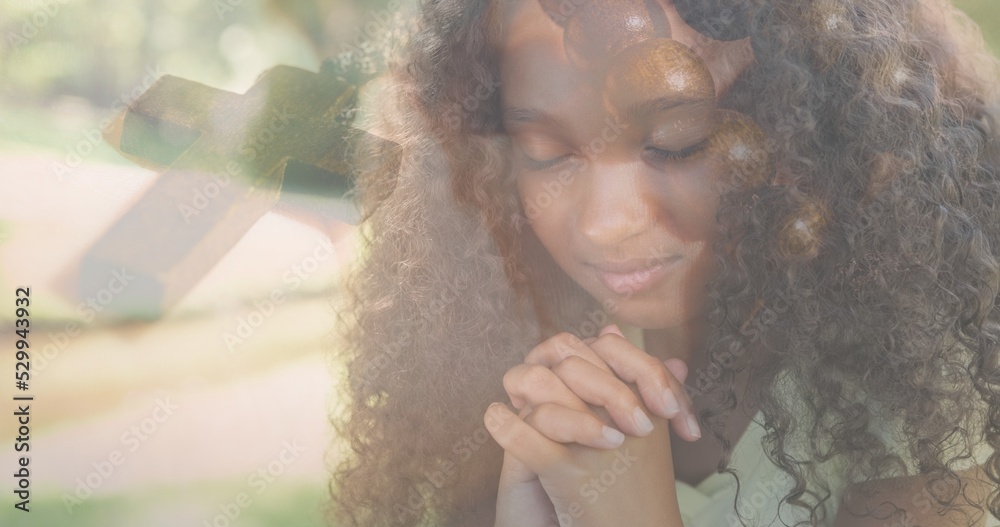 Obraz premium Multiple exposure of biracial elementary girl praying and rosary on bible