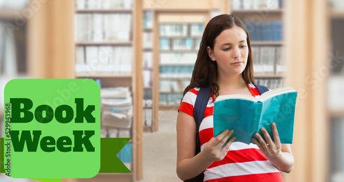 Book week text over caucasian teenage girl reading book while standing in library