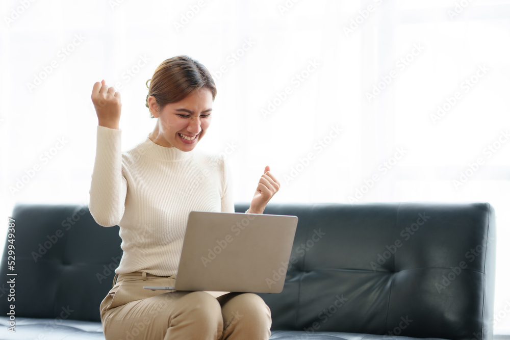 Young Asian business women are delighted and happy with their work and success on their laptop at home. Young Asian business women are delighted and happy with their work and success on their laptop at home.