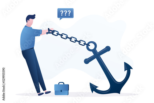Businessman is chained to a large anchor. Severe insurmountable circumstances hinder business person. Mental problems, credit debt. Business troubles. photo