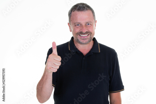 middle age man feeling proud,smiling positively with thumbs up on white background