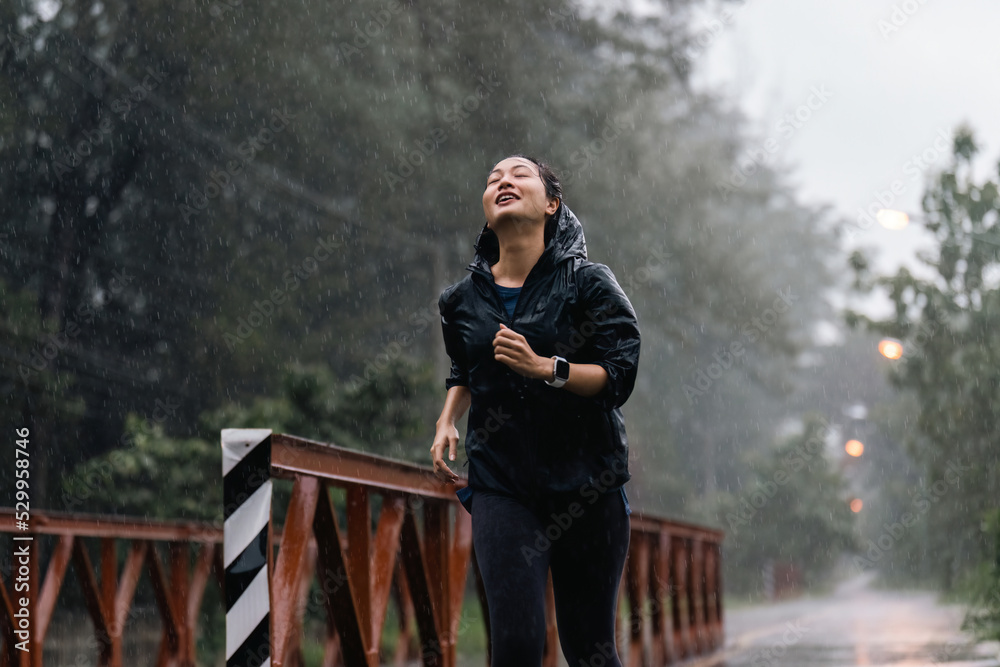 Fototapeta premium Asian ladies running in the rain