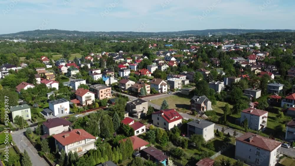 Flyover of Polish houses, train tracks, speedway, sports stadium, and