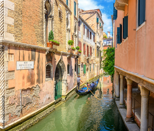 View on the narrow cozy streets of the canals with gondolas one of the symbols of Venice, Italy. Architecture and landmark of Venice.