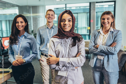 Group of modern multicultural young business women and business man in casual wear in the creative office.