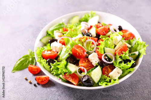 fresh mixed salad with tomato,  lettuce,  olive and feta cheese