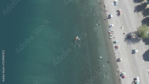 top down view of people bathing in the Ranco lake in chile in the blue and teal waters with people paddleboarding photo