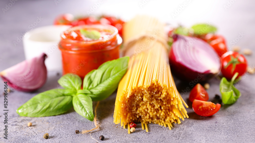 raw spaghetti composition with tomato, basil and spice raw spaghetti composition with tomato, basil and spice