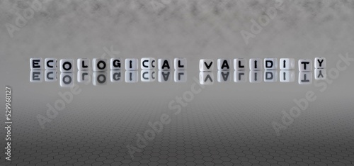 ecological validity word or concept represented by black and white letter cubes on a grey horizon background stretching to infinity