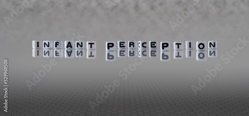 infant perception word or concept represented by black and white letter cubes on a grey horizon background stretching to infinity