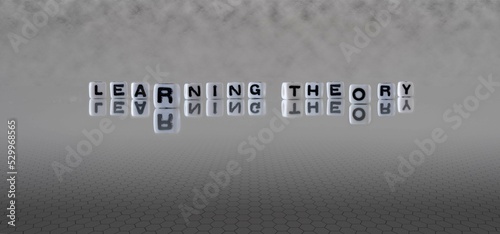 learning theory word or concept represented by black and white letter cubes on a grey horizon background stretching to infinity