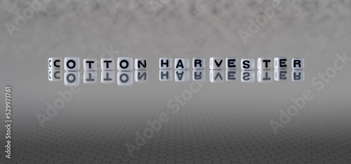 cotton harvester word or concept represented by black and white letter cubes on a grey horizon background stretching to infinity