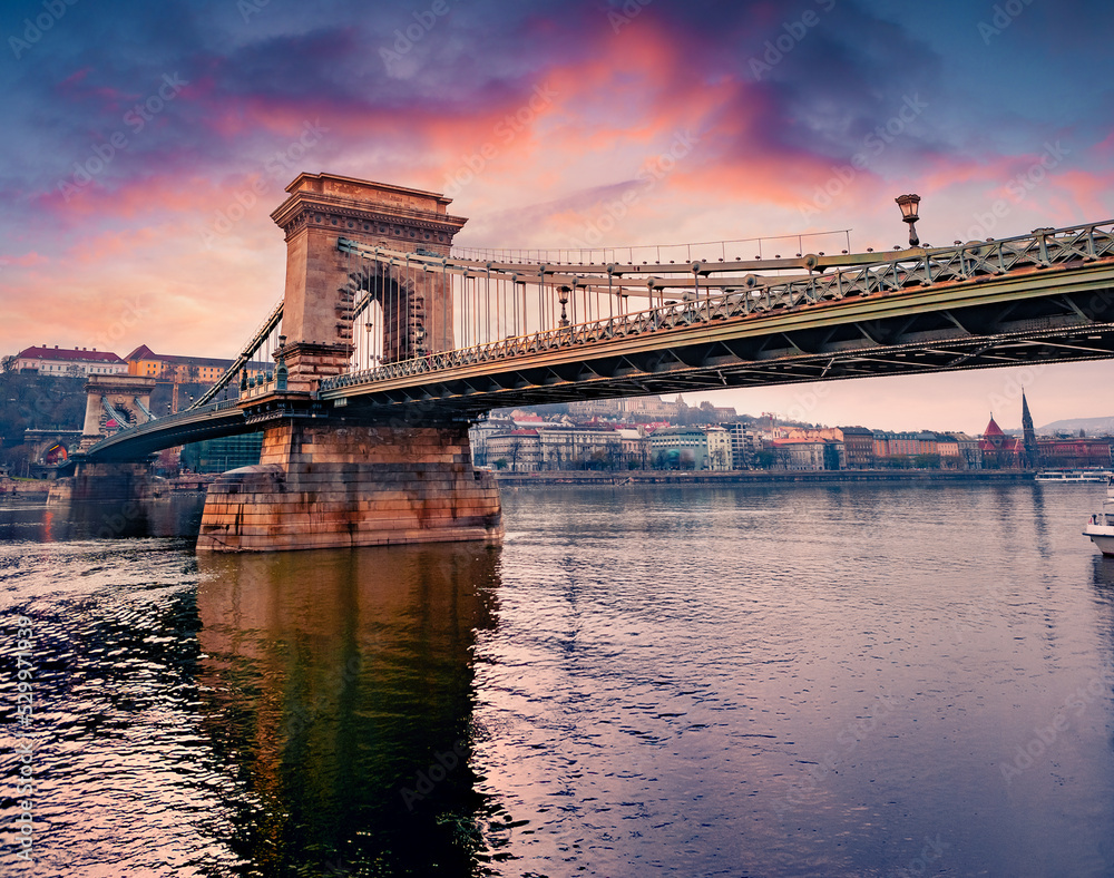 Fototapeta premium Great spring cityscape of Budapest town, capital of Hungary, Europe. Picturesque sunrise on Danube river with Chain Bridge. Traveling concept background.