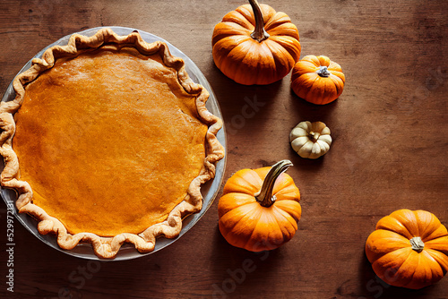 Pumpkin pie on a wooden table top view.AI