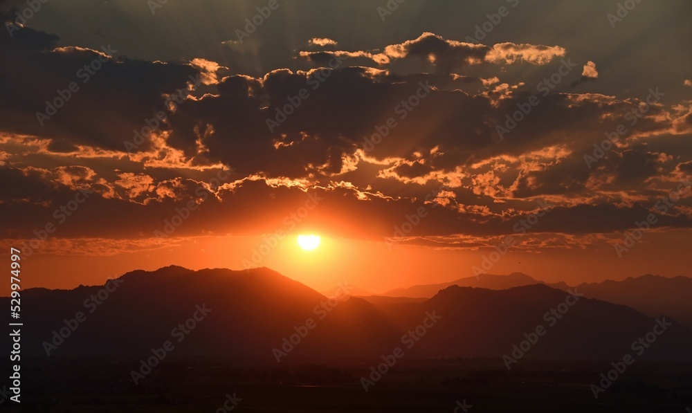 fiery sunset over the front range of the colorado mountains due to the smoke from the western forest fires, as seen from broomfield, colorado fiery sunset over the front range of the colorado mountains due to the smoke from the western forest fires, as seen from broomfield, colorado