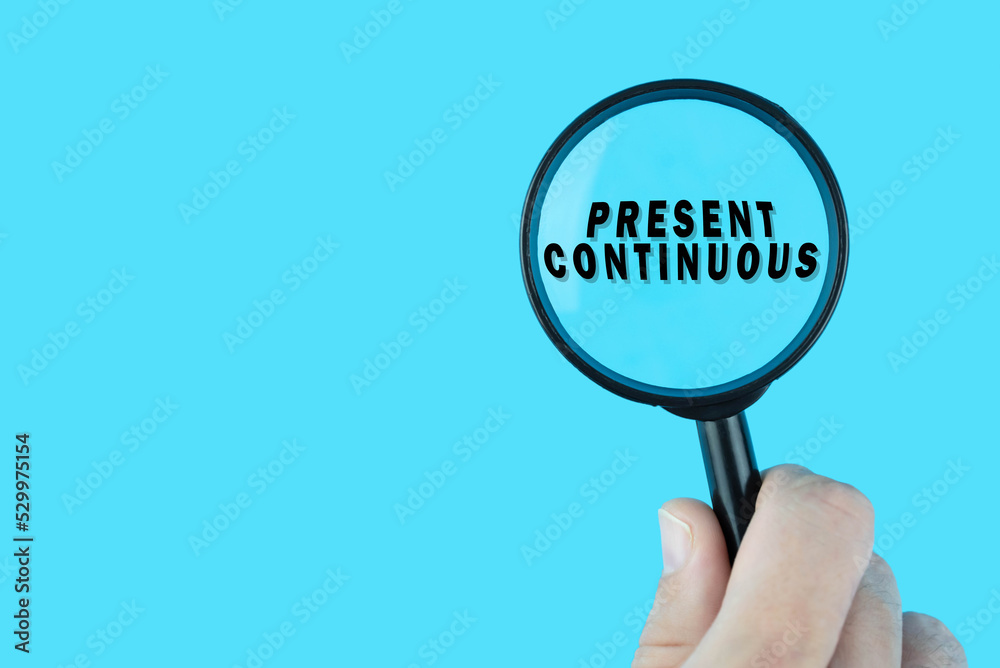 Focused on learning English language. Basic English tenses. Present continuous under magnifying glass. Grammar content for teacher and student. Focused on learning English language. Basic English tenses. Present continuous under magnifying glass. Grammar content for teacher and student.