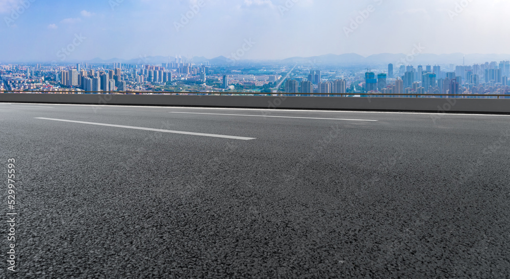Empty road and city buildings background Empty road and city buildings background
