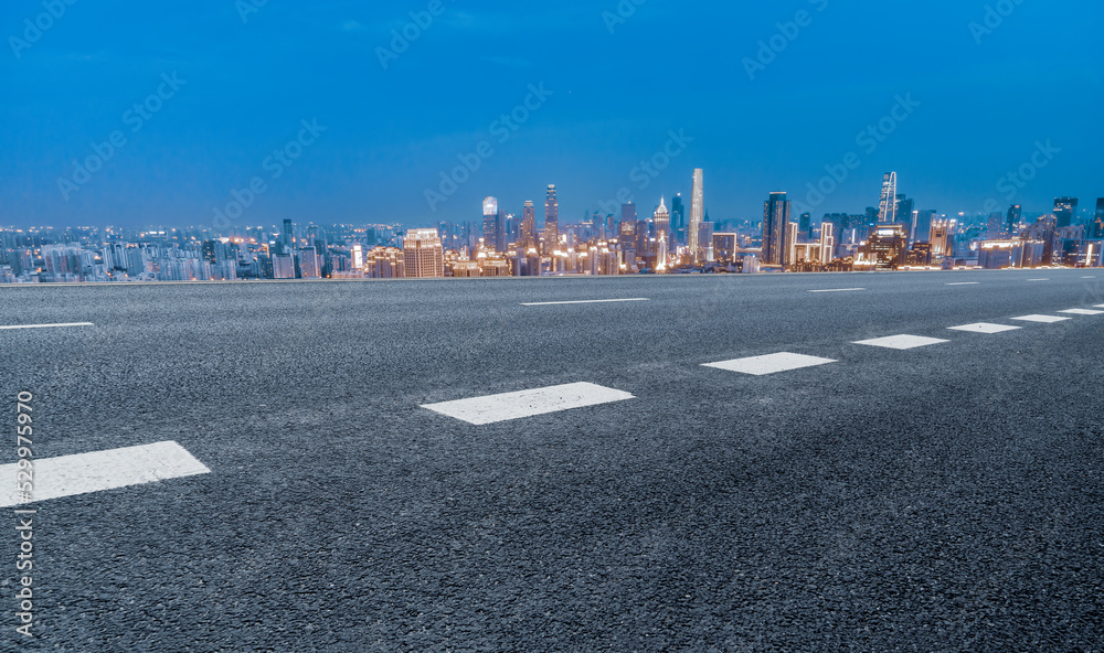 Empty road and city buildings background Empty road and city buildings background