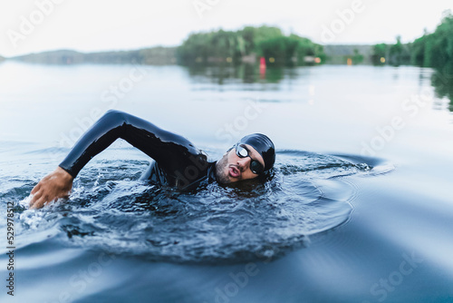 Man splashing water swimming in lake