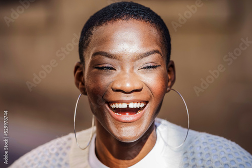 Happy woman with gap toothed wearing hoop earrings
