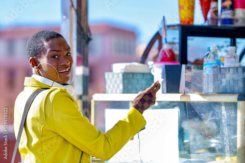 Woman looking over shoulder standing at concession stand photo