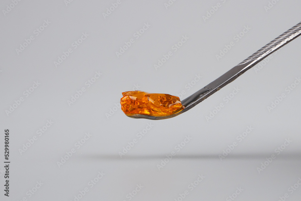 detail of resin wax of marijuana concentrate on dabbing tool detail of resin wax of marijuana concentrate on dabbing tool
